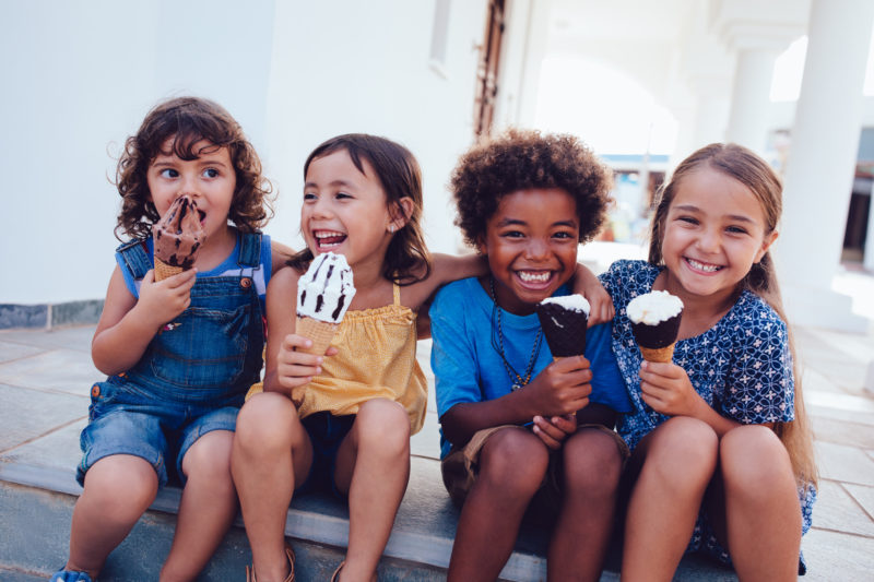 Group Of Cheerful Multi Ethnic Children Eating Ice Cream In Summer