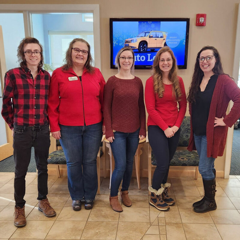 Five cPort Maine credit union employees posing together for a photo to show off their red shirts worn for the American Heart Association’s Go Red for Women Day.