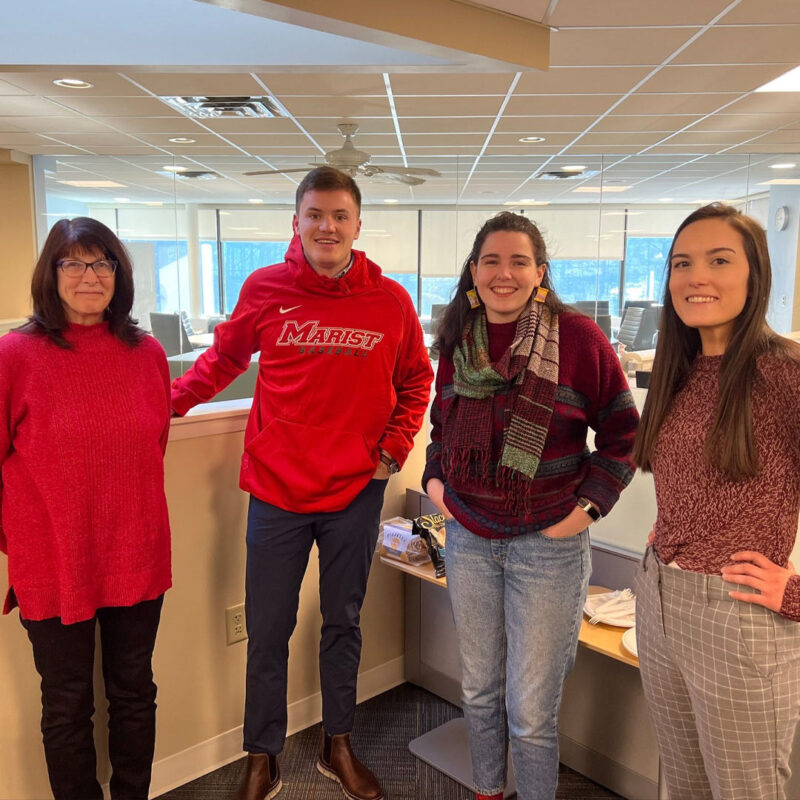 Four employees wearing red for the American Heart Association’s “Go Red for Women Day” at cPort Credit Union in Maine.