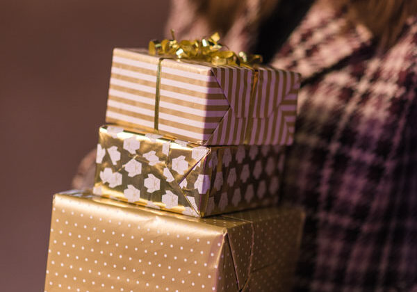 Holiday Club Woman Holding Gifts