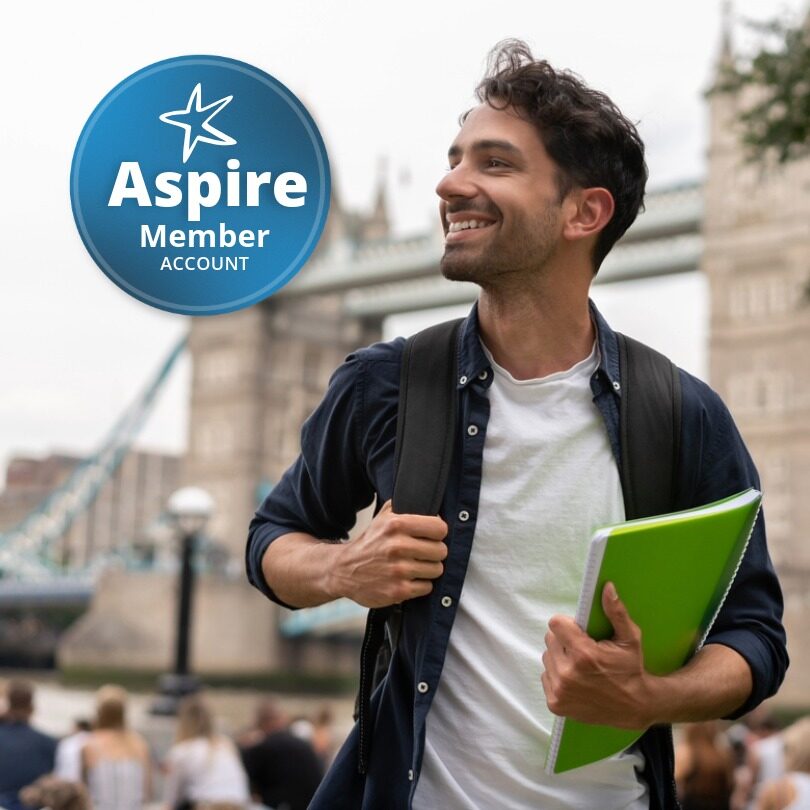 Portrait of a happy student in London holding a notebook and smiling near Tower Bridge