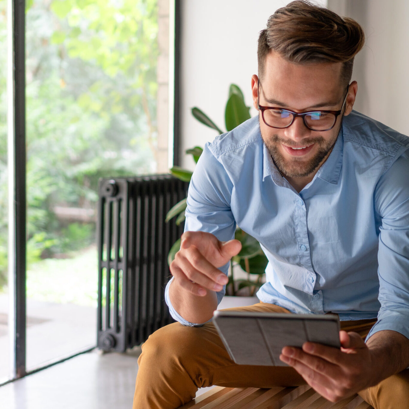 man holding a tablet to illustrate how easy it is to monitor your credit and protect your identity