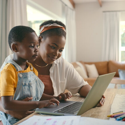 Mother looking at computer with son